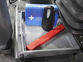 A storage compartment for for example tools is located below the cabin.
